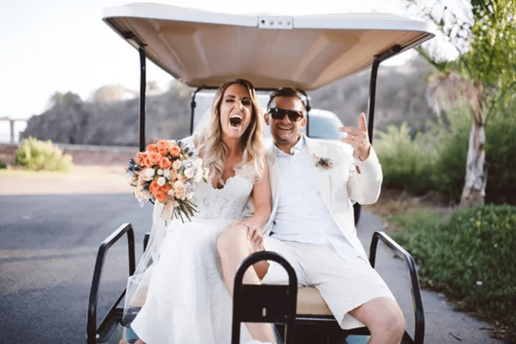 Bride and groom celebrating on golf cart